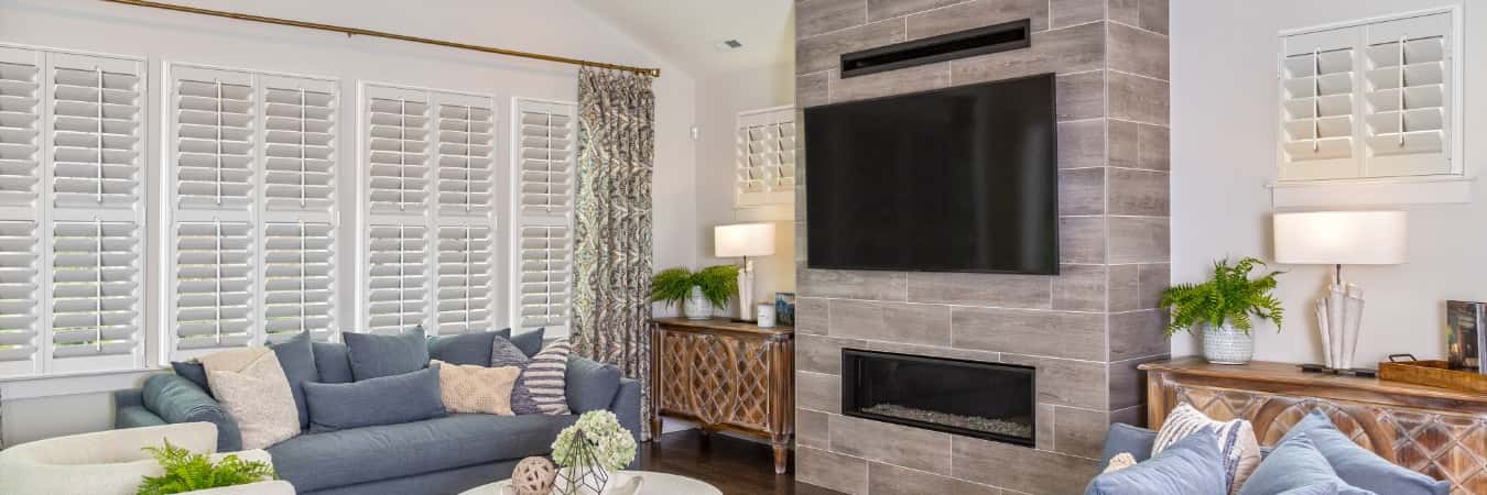 Plantation shutters in Chincoteague family room with fireplace